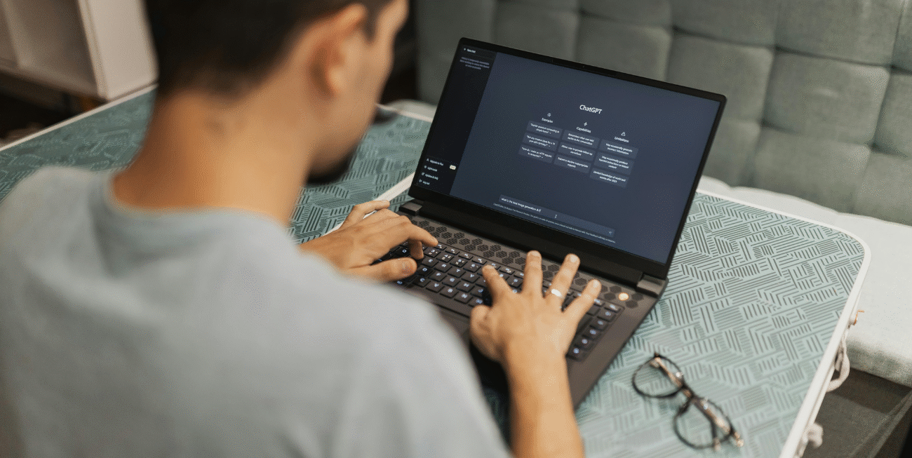 Man using ChatGPT on laptop, reflecting the gap between AI content and Google rankings.